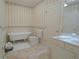 Well-lit bathroom with clawfoot tub, toilet, vanity, and patterned floor at 1811 Murdock Rd, Marietta, GA 30062