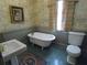 Charming bathroom with clawfoot tub, vintage-style wallpaper, and classic fixtures at 1811 Murdock Rd, Marietta, GA 30062