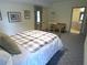 Comfortable bedroom with plaid bedding and a view into an adjacent bathroom at 1811 Murdock Rd, Marietta, GA 30062