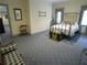 Cozy bedroom features a brass bed frame and blue patterned carpet at 1811 Murdock Rd, Marietta, GA 30062