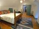 Bedroom with four-poster bed, hardwood floors, rug, and blue trim at 1811 Murdock Rd, Marietta, GA 30062