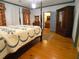 Bedroom with four-poster bed, wood floors, and a glimpse into an adjacent room at 1811 Murdock Rd, Marietta, GA 30062