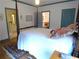 Bedroom with four-poster bed, hardwood floors, and views to an adjacent room at 1811 Murdock Rd, Marietta, GA 30062