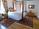 Bedroom with four-poster bed, hardwood floors, and traditional decor at 1811 Murdock Rd, Marietta, GA 30062