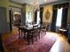 Elegant dining room features hardwood floors, wainscoting, a chandelier, and a large table for gatherings at 1811 Murdock Rd, Marietta, GA 30062