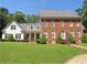 Traditional two-story home with brick and clapboard, featuring a covered porch and green lawn at 1811 Murdock Rd, Marietta, GA 30062