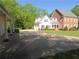 View of the beautiful home from the driveway, showing brick and siding design and attached garage at 1811 Murdock Rd, Marietta, GA 30062