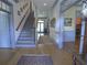 Welcoming foyer with hardwood floors, staircase, blue trim and view through to the front entry door at 1811 Murdock Rd, Marietta, GA 30062