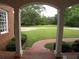 View from the front porch showcasing a beautiful lawn, brick walkway and mature trees, creating a serene entry at 1811 Murdock Rd, Marietta, GA 30062