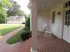Classic front porch with white rocking chairs, brick steps and walkway leading to a detached garage at 1811 Murdock Rd, Marietta, GA 30062