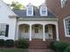 Charming front porch with rocking chairs, white columns, and brick steps offer a relaxing outdoor space at 1811 Murdock Rd, Marietta, GA 30062