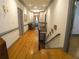 Hallway with hardwood floors, gray trim, leading to a bench beneath a window at the end of the hall at 1811 Murdock Rd, Marietta, GA 30062