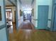 Inviting hallway with hardwood floors and blue trim offering glimpses into other rooms at 1811 Murdock Rd, Marietta, GA 30062