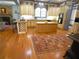 Eat-in kitchen includes hardwood floors, island, custom cabinets, stone fireplace, and modern appliances at 1811 Murdock Rd, Marietta, GA 30062