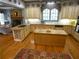 This eat-in kitchen includes hardwood floors, an island, custom cabinets, and a stone fireplace at 1811 Murdock Rd, Marietta, GA 30062