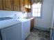 Functional laundry room featuring modern washer and dryer and wash sink at 1811 Murdock Rd, Marietta, GA 30062