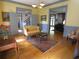 Inviting living room features hardwood floors, soft yellow walls, and stylish furniture under a beautiful chandelier at 1811 Murdock Rd, Marietta, GA 30062
