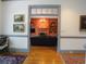 Open doorway view of cozy living room with fireplace, built-in shelves, and a dark leather sofa at 1811 Murdock Rd, Marietta, GA 30062