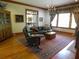 Comfortable living room with hardwood floors, large windows, a fireplace, and vintage-style furniture at 1811 Murdock Rd, Marietta, GA 30062