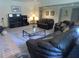 Open-concept living room with carpeting, comfortable seating, and entertainment setup with TV at 1811 Murdock Rd, Marietta, GA 30062