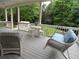 Covered porch features wicker furniture, ceiling fan, porch swing, and view of the private, tree-lined backyard at 1811 Murdock Rd, Marietta, GA 30062