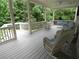 Comfortable covered porch with white wicker furniture and ceiling fan offers space to relax outdoors at 1811 Murdock Rd, Marietta, GA 30062