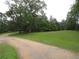 Gravel driveway leading to an expansive green lawn at 1811 Murdock Rd, Marietta, GA 30062