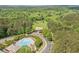 Aerial view of community with pool, clubhouse, and surrounding mature trees at 2121 Harmony Dr, Canton, GA 30115