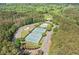 Aerial view of tennis courts, clubhouse, and pool in a beautiful wooded setting at 2121 Harmony Dr, Canton, GA 30115