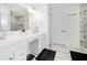 Modern bathroom features double vanity, decorative mirrors, and tiled walls and floors at 2121 Harmony Dr, Canton, GA 30115