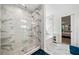 Updated shower features marble-look tiles and sliding glass doors, plus a peek into the bedroom at 2121 Harmony Dr, Canton, GA 30115