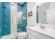 Bathroom featuring a tiled shower with glass doors, white vanity, and modern fixtures at 2121 Harmony Dr, Canton, GA 30115