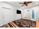 Bright bedroom featuring a ceiling fan, television, closet, and a view into the bathroom at 2121 Harmony Dr, Canton, GA 30115