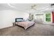 Bright bedroom features tray ceilings, ceiling fan, a gray dresser, and egg chair for relaxing at 2121 Harmony Dr, Canton, GA 30115