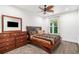 Bedroom showcasing a wooden dresser and bed with a ceiling fan and outdoor views at 2121 Harmony Dr, Canton, GA 30115