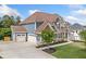 Two-story home with attached garages, well-manicured lawn, and stone accents on a sunny day at 2121 Harmony Dr, Canton, GA 30115
