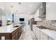 Open-concept kitchen flows into bright living area, with stainless appliances, and marble countertops at 2121 Harmony Dr, Canton, GA 30115