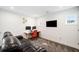Loft area with a home office setup including an orange chair, dual monitors and a leather couch at 2121 Harmony Dr, Canton, GA 30115