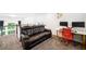 Open loft area showcasing a leather couch, desk with dual monitors and staircase at 2121 Harmony Dr, Canton, GA 30115