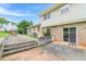 Brick home featuring an outdoor patio with steps to a yard with green grass and landscaping at 3947 Veracruz Ct, Decatur, GA 30034