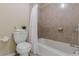 Bathroom with tiled shower-tub combination, toilet, and neutral walls at 3947 Veracruz Ct, Decatur, GA 30034