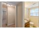 Well-lit half bath with updated vanity, toilet, and window at 3947 Veracruz Ct, Decatur, GA 30034