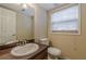 Well-lit half bath with updated vanity, toilet, and window at 3947 Veracruz Ct, Decatur, GA 30034