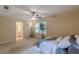 Spacious bedroom with a ceiling fan, neutral walls, and an adjoining bathroom at 3947 Veracruz Ct, Decatur, GA 30034