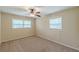 Bedroom featuring two windows, neutral carpet and light tan walls at 3947 Veracruz Ct, Decatur, GA 30034