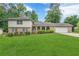 Charming brick and siding home with a well-manicured lawn, attached garage, and attractive landscaping at 3947 Veracruz Ct, Decatur, GA 30034