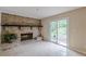 Cozy living room with a classic brick fireplace and sliding glass doors to the patio at 3947 Veracruz Ct, Decatur, GA 30034