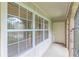 Covered porch featuring multiple windows and a doorway to a storage area at 3947 Veracruz Ct, Decatur, GA 30034