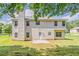 Full view of the back exterior with a concrete patio and green lawn at 4938 Wewatta Sw St, Atlanta, GA 30331