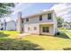 Exterior view of the home with a grassy backyard and a concrete patio at 4938 Wewatta Sw St, Atlanta, GA 30331